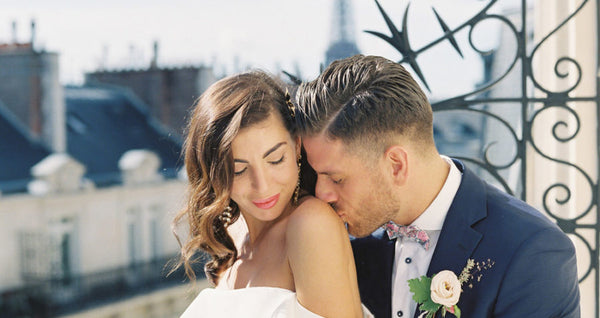 Bride and groom kissing in vintage Paris balcony