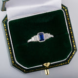 Emerald cut blue sapphire ring with baguettes in box