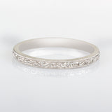 Platinum engraved wedding ring with scroll