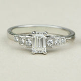 Art Deco emerald cut diamond engagement ring with diamond band 