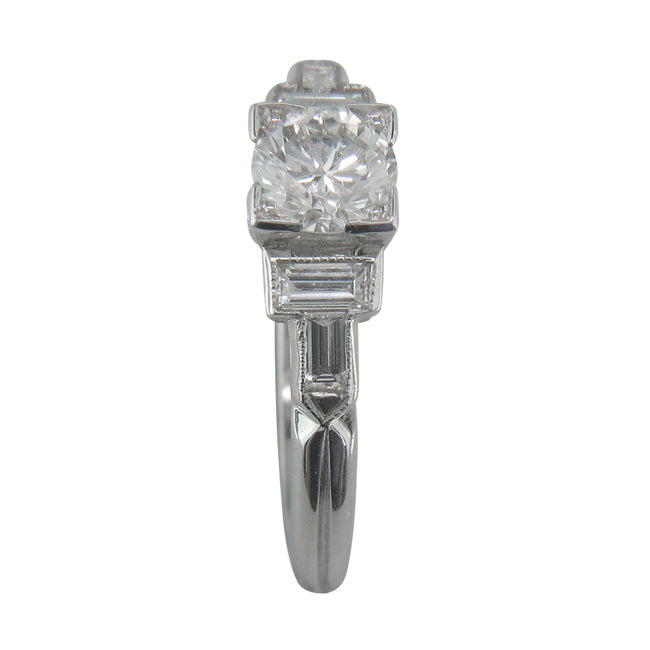Diamond and white gold ring with baguette diamond side stones.