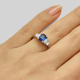 Emerald cut blue sapphire gemstone ring with baguette diamonds