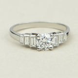 Round diamond ring with baguettes in platinum