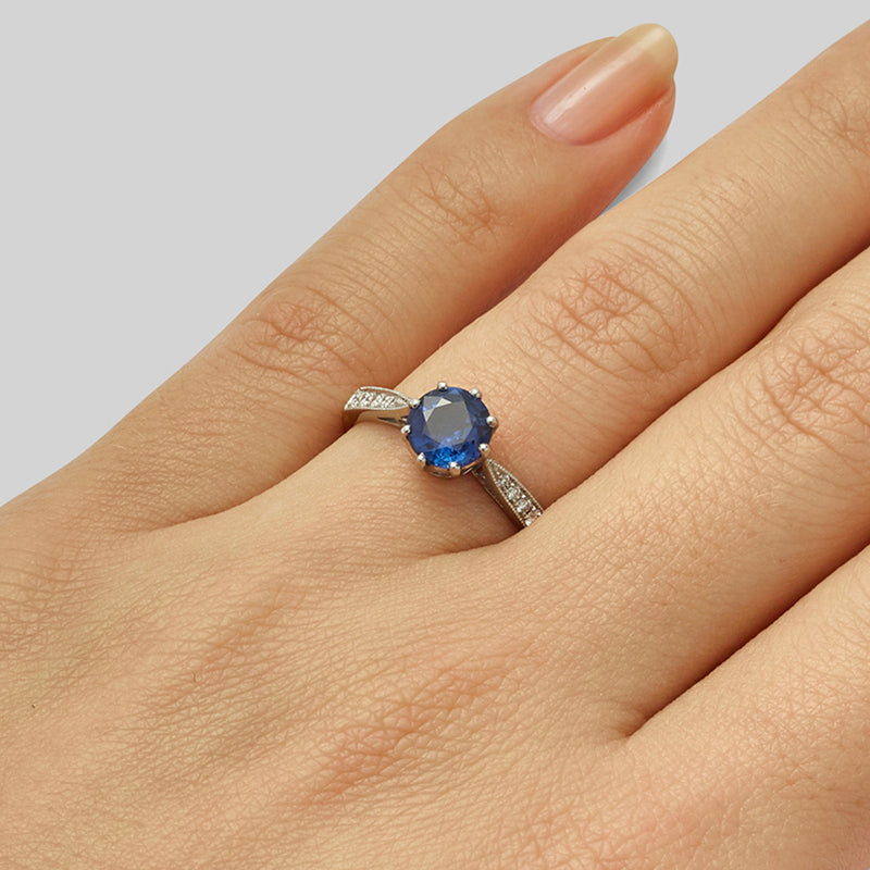 Round brilliant solitaire sapphire engagement ring with diamonds