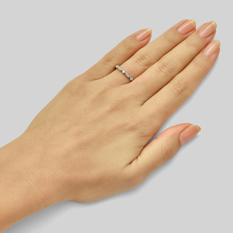 Scalloped diamond wedding ring on lady's hand