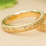 Floral engraved wedding ring in yellow gold