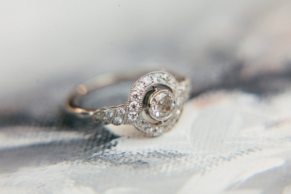 Edwardian round diamond cluster ring with diamond halo