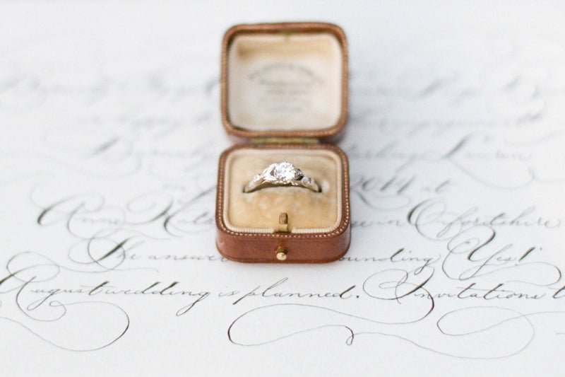 Round diamond engagement ring with leaf patterns