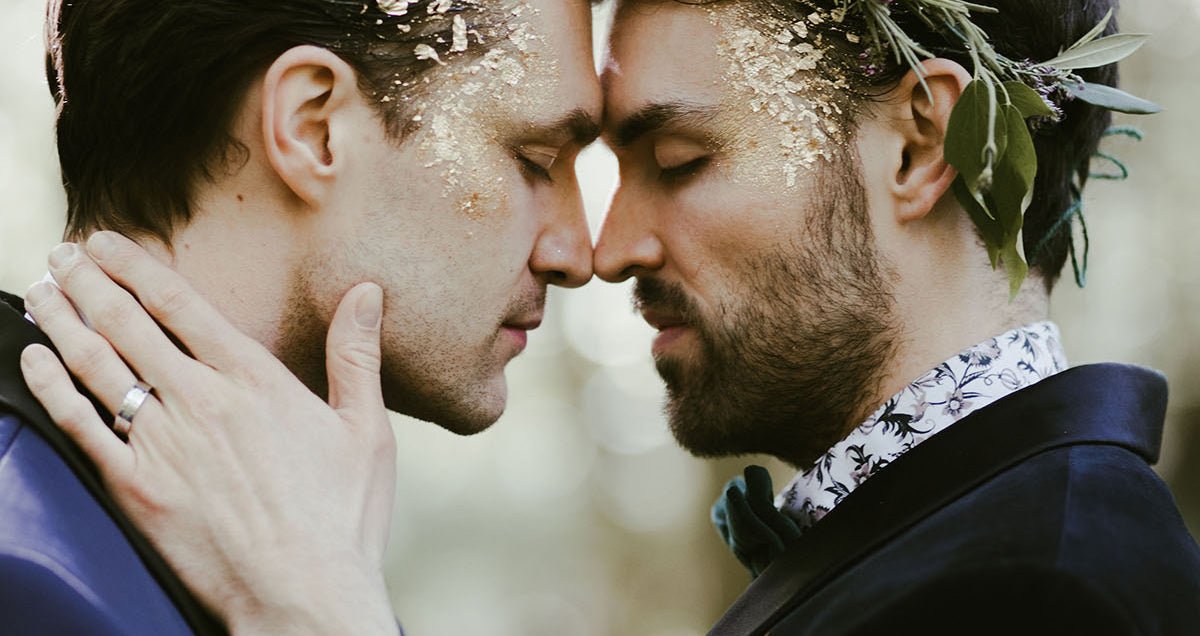 Groom and groom with wide platinum wedding band