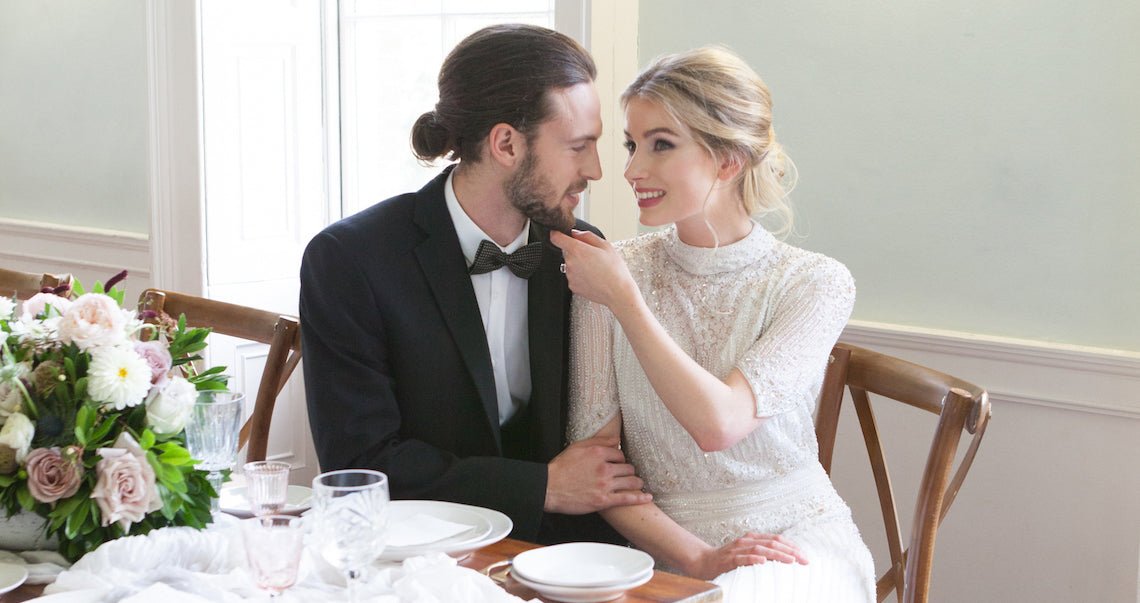 Bride and groom sat together at wedding table in London wedding