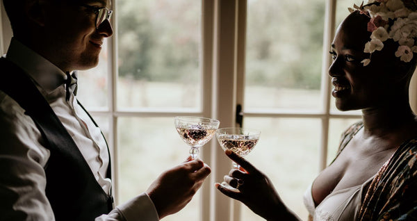 Bride and groom toasting glasses for glasshouse wedding ceremony