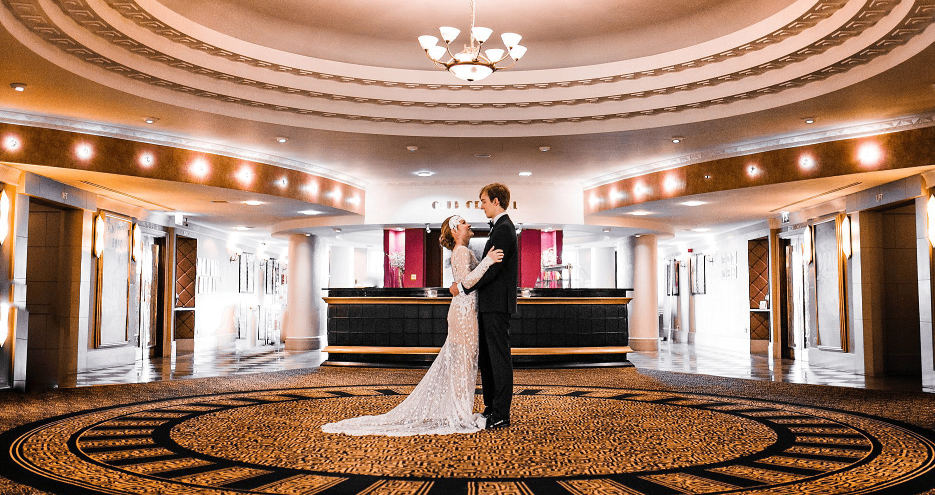 Bride and groom in large ballroom for Gatsby style Art Deco wedding