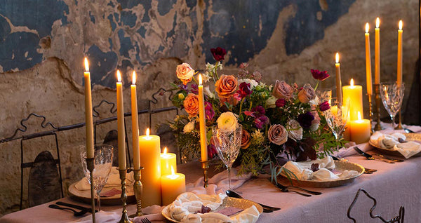 Table arrangements with central bouquet and many candles