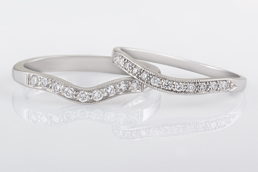 Curved diamond platinum wedding bands for women