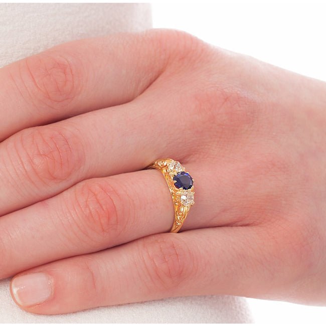 Victorian style sapphire three stone ring on hand