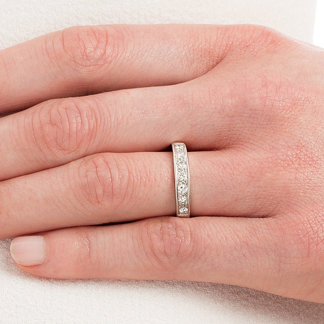 Seven stone diamond band in white gold on hand