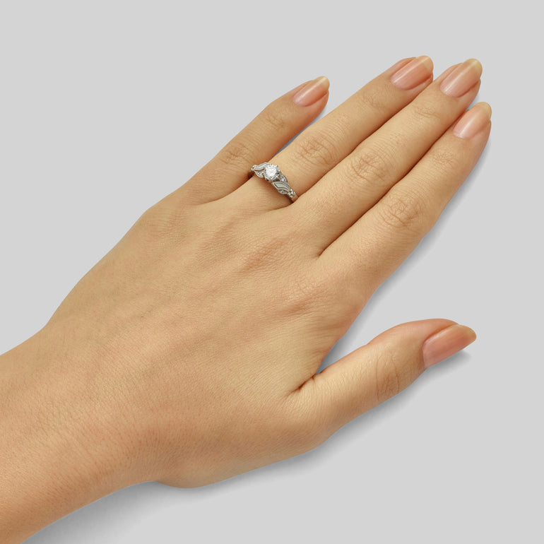 Edwardian round brilliant cut diamond engagement ring with floral design
