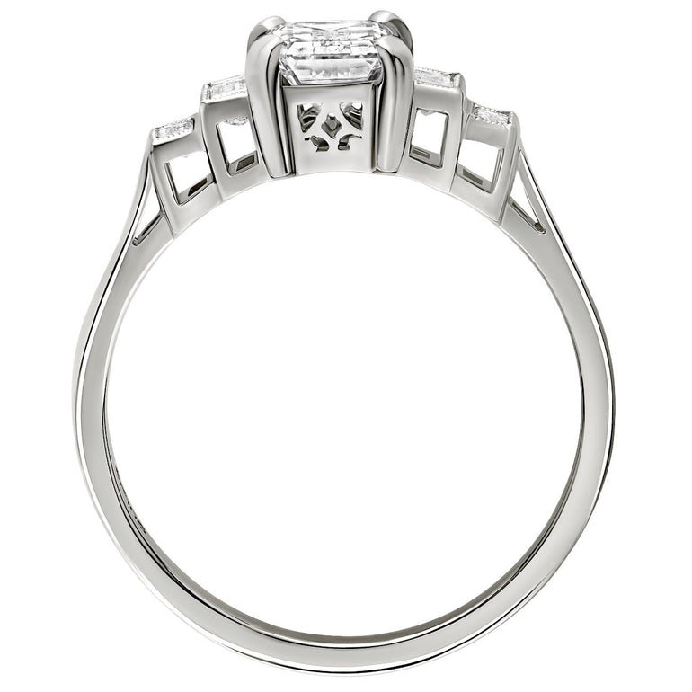 Art deco style emerald cut diamond ring with graduated baguette side stones and fine milgrain detailing, made in London, UK