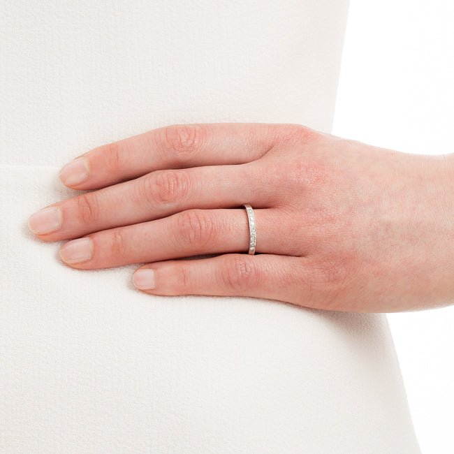 Model wearing diamond wedding band in UK.