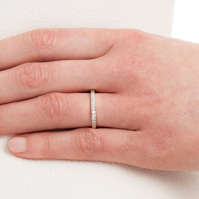 Diamond wedding band in platinum on hand