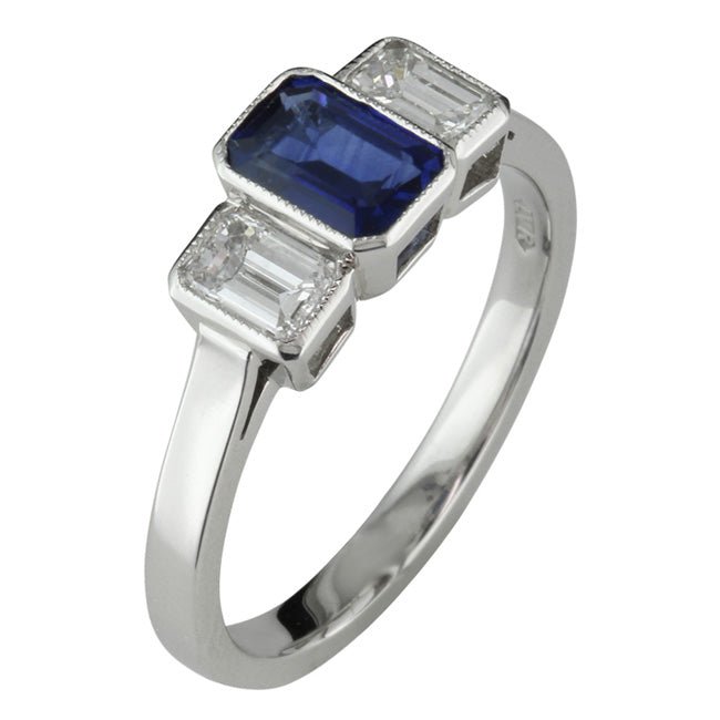 Sapphire engagement ring in Art Deco style with emerald cut diamonds.