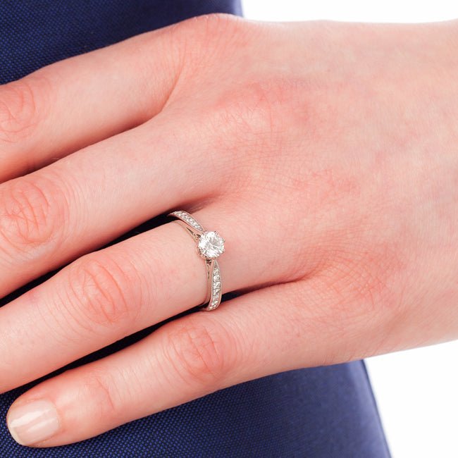 Classic 8-claw engagement ring with millegrain band on hand