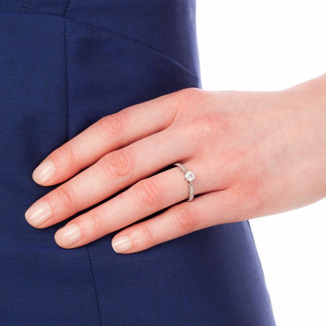 Platinum and round diamond ring with diamond band worn by model