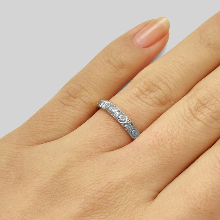 Camellia japonica flower engraved wedding ring on hand