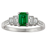 Emerald gemstone and diamond accents on a white background made in London.