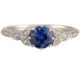 Platinum ring with round blue sapphire and diamond with floral engraved band made in Hatton Garden in London
