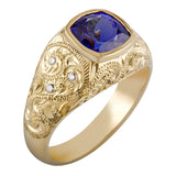 Gold ring with a blue gemstone and diamond accents on a white background