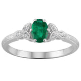 Emerald oval centre stone engagement ring with diamond detailing in platinum made in London UK