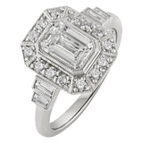 Emerald cut diamond ring with halo clister and baguette side stones in platinum. Made in the UK
