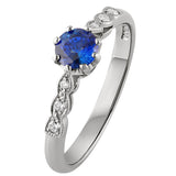 Blue sapphire engagement ring with side diamonds in platinum. Made in London.