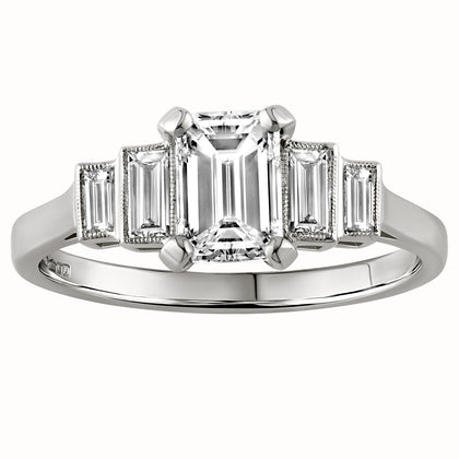 Emerald cut diamond engagement ring with baguette side stones in a stepped design, crafted in white metal, made in London, UK 