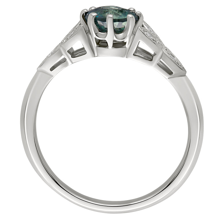 Platinum engagement ing with a round green sapphire centre stone, diamond clusters in a leaf-inspired design. Made in London