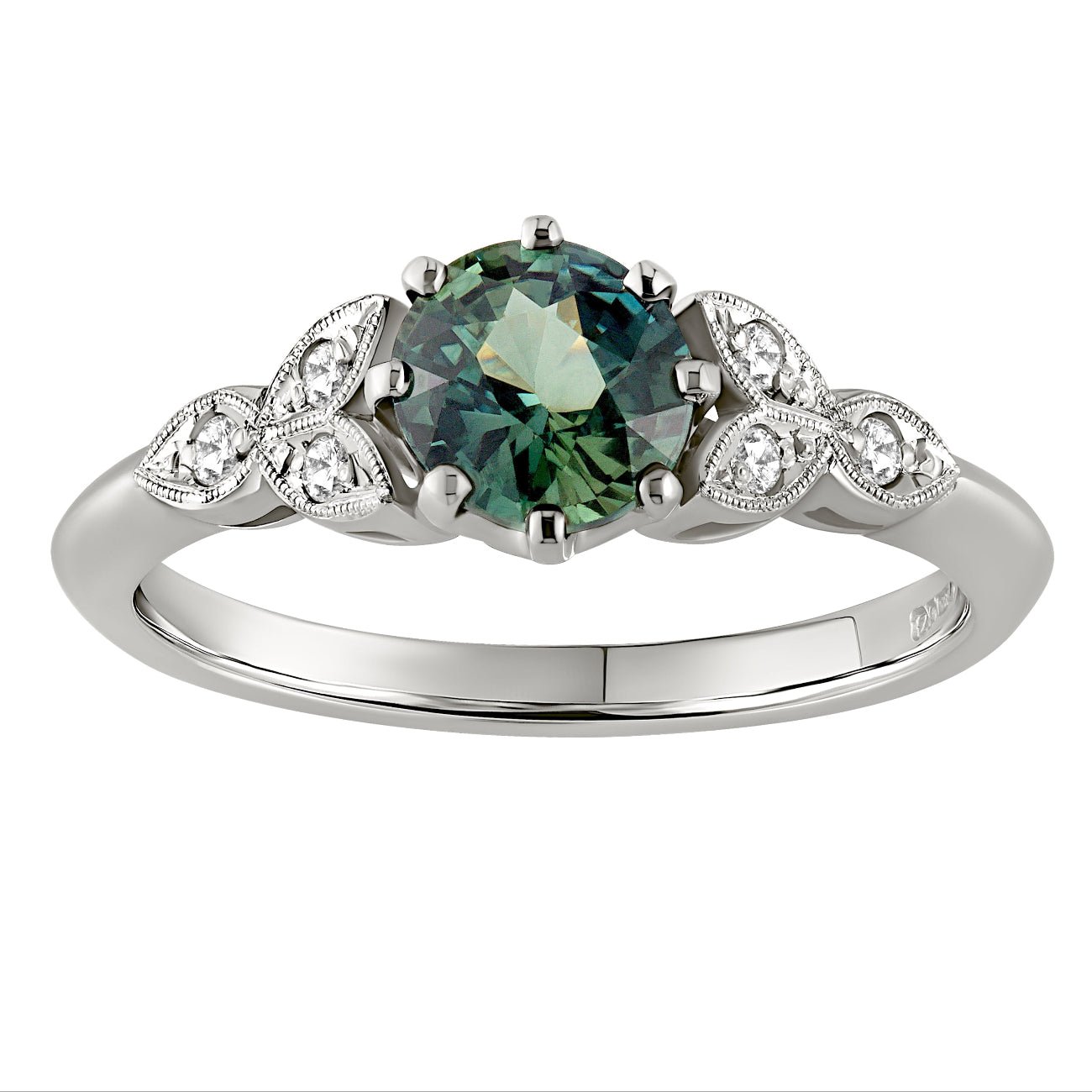 Floral style engagement ring with green sapphire and diamonds on the shoulders. Made in the UK