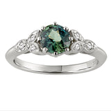 Floral style engagement ring with green sapphire and diamonds on the shoulders. Made in the UK