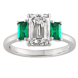Emerald cut lab grown diamond trilogy ring with natural emerald side stones set in platinum. Made in the UK
