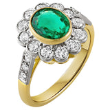 Emerald and diamond cluster ring with oval emerald centre, platinum diamond halo and yellow gold band. Made in Hatton Garden