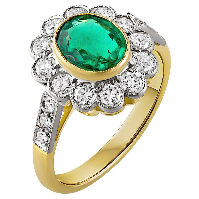 Emerald and diamond cluster ring with oval emerald centre, platinum diamond halo and yellow gold band. Made in Hatton Garden