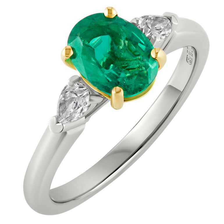 Oval emerald engagement ring set with yellow gold claws, pear-cut diamond shoulders and platinum band. Made in the UK