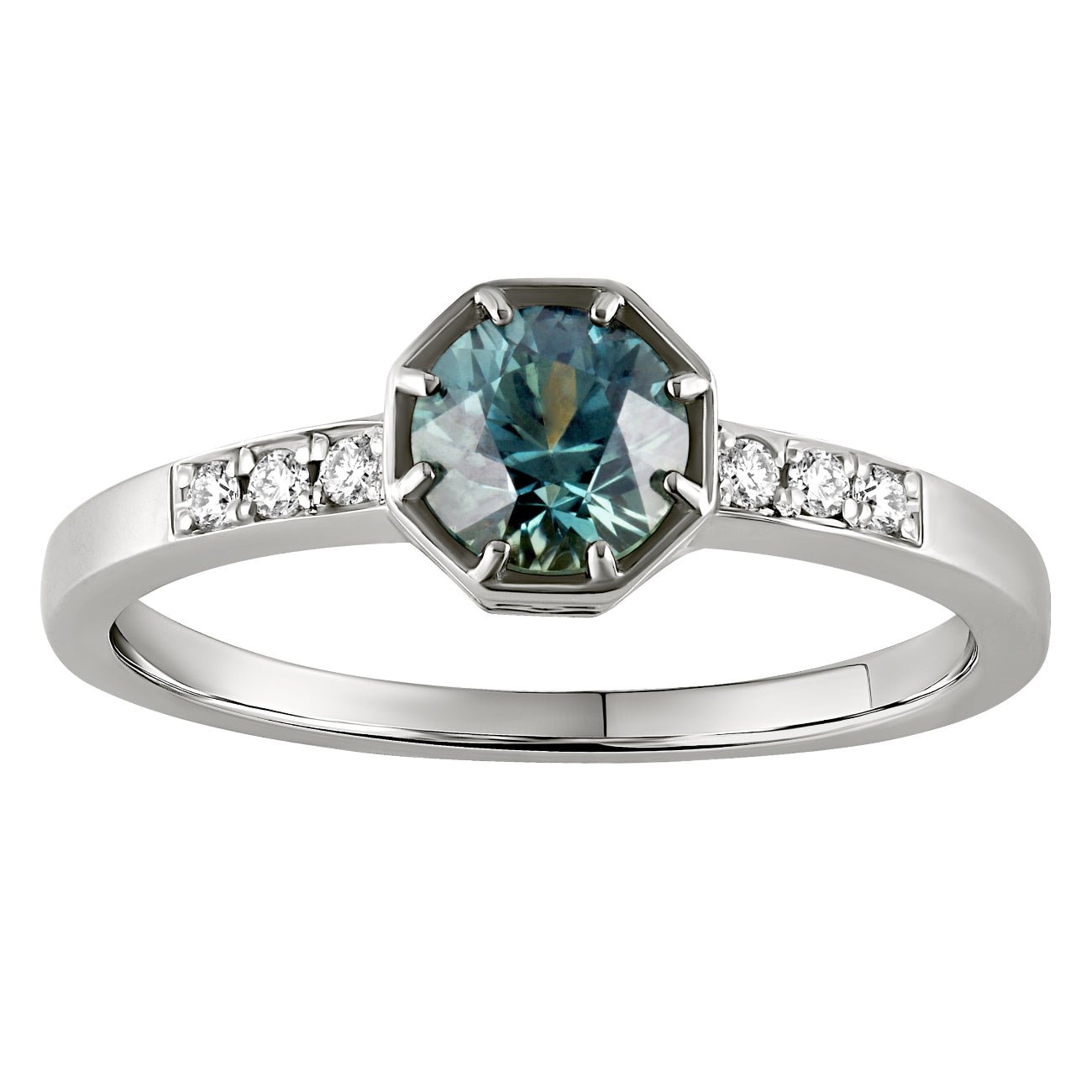 Teal sapphire engagement ring made in London, Hatton Garden, featuring a round cut teal stone with diamond accents on a platinum band.