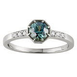 Teal sapphire engagement ring made in London, Hatton Garden, featuring a round cut teal stone with diamond accents on a platinum band.