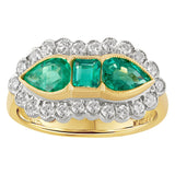 emerald and diamond cluster ring in yellow gold, featuring three green emeralds surrounded by a halo of round brilliant diamonds. Made in the UK.