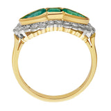 Vintage Three-stone emerald and diamond cluster ring featuring a central emerald-cut emerald with pear-cut emeralds on each side, surrounded by a halo of round brilliant diamonds in a yellow gold and platinum setting. Made in Hatton Garden.