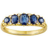 Five-stone blue sapphire half hoop ring with diamond points and carved scrollwork in yellow gold. Made in the UK
