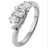 3 stone diamond engagement ring with blue sapphires on the sides. Made in the UK.
