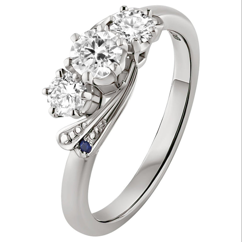 3 stone diamond engagement ring with blue sapphires on the sides. Made in the UK.