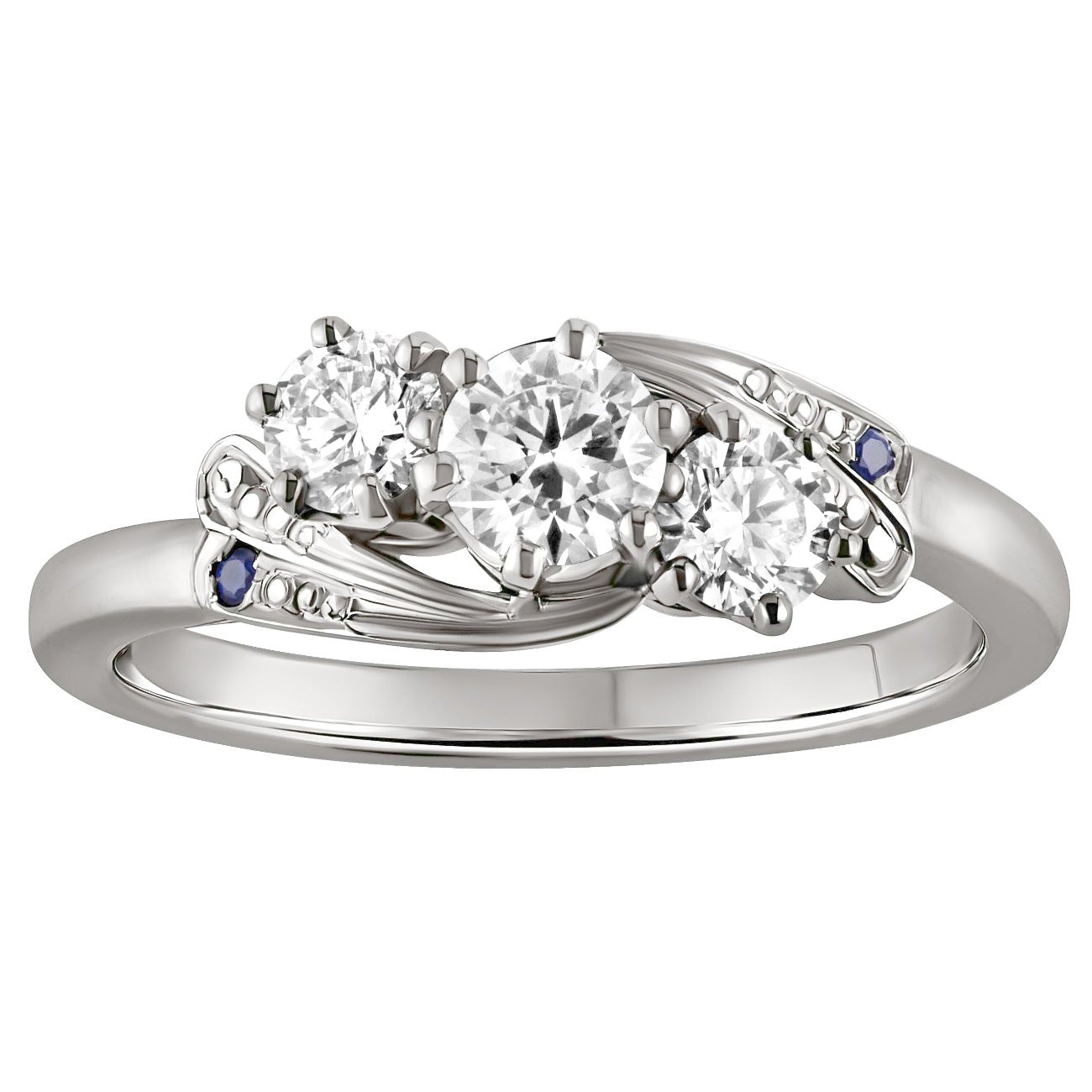 Bespoke trilogy diamond ring in platinum with three round diamonds and blue sapphire shoulder stones in platinum. Made in London